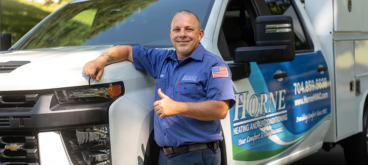 HVAC technician with service truck
